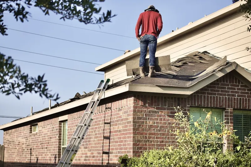 Professional roofer working on a residential roof in Hunters Woods